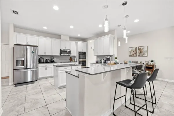 a kitchen with appliances a sink and cabinets
