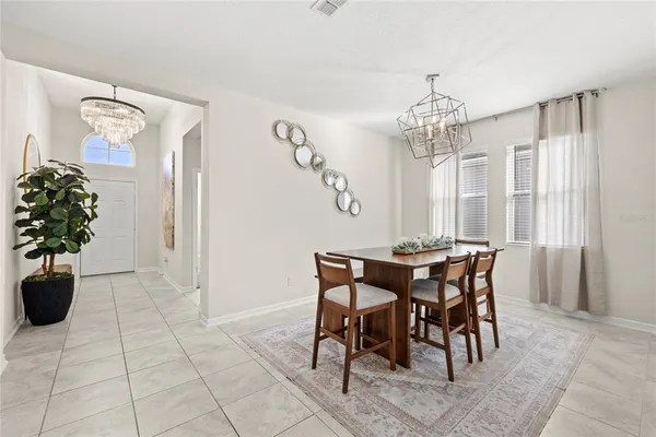 a view of a dining room with furniture and chandelier