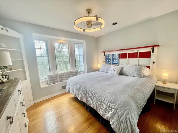 a bedroom with a bed and a large window