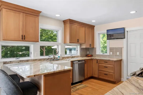 a kitchen with a sink window and cabinets