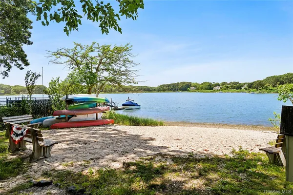 a view of a lake with a table and chairs