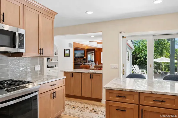 a kitchen with stainless steel appliances a stove sink and microwave