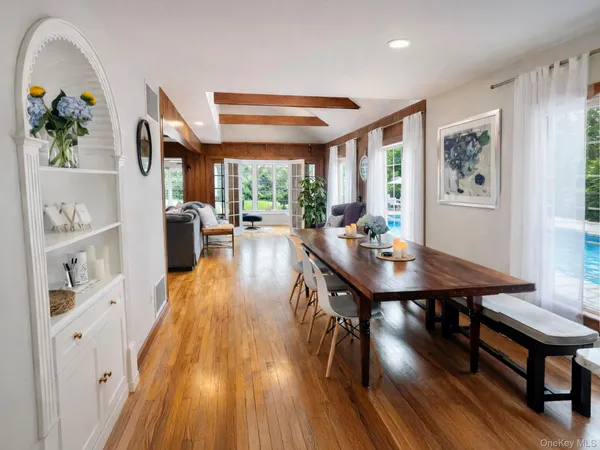 a view of a dining room with furniture window and wooden floor