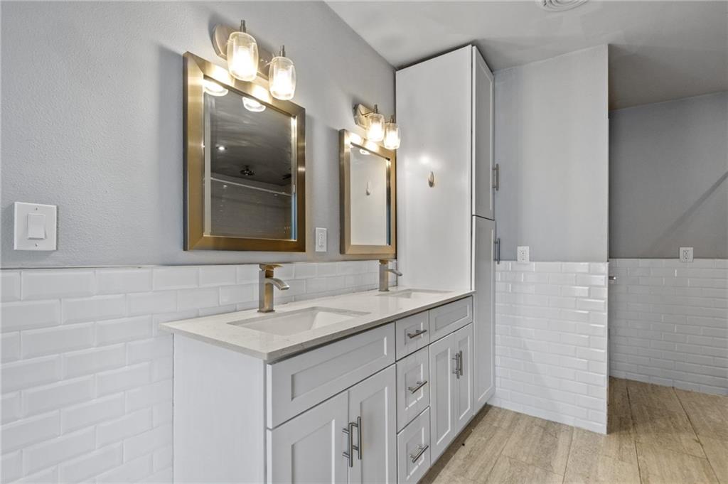 2105 Fortview Road Austin, TX 78704 - Photo 23 of 37 Twin vanities offer ample counter space and storage in this elegant primary bathroom.