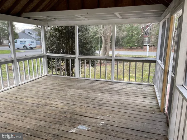 a view of a balcony with wooden floor