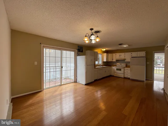 a view of a kitchen with a sink and a window