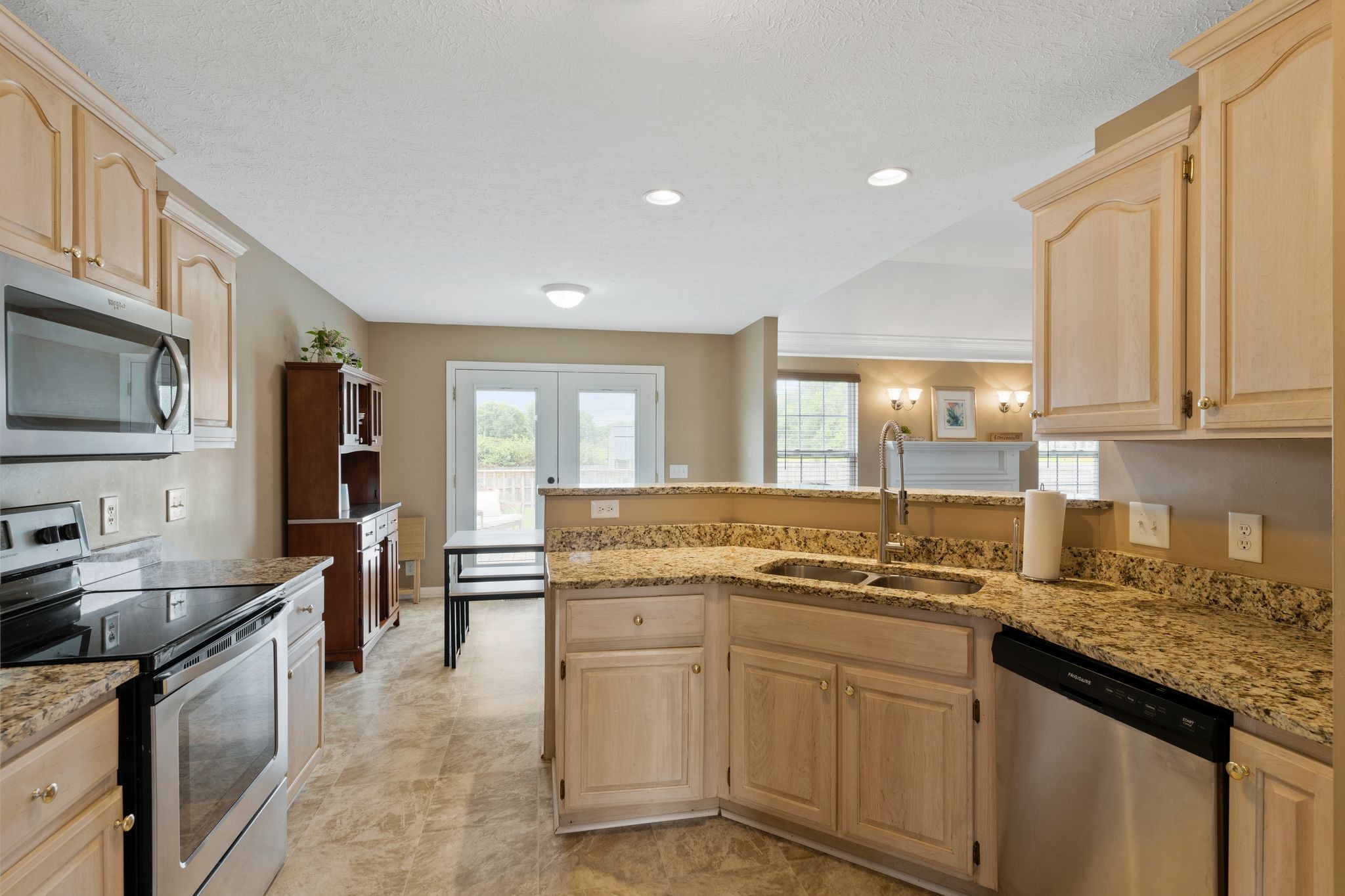 153 Cornerstone Boulevard Portland, TN 37148 - Photo 11 of 30 a kitchen with stainless steel appliances granite countertop a sink stove and cabinets