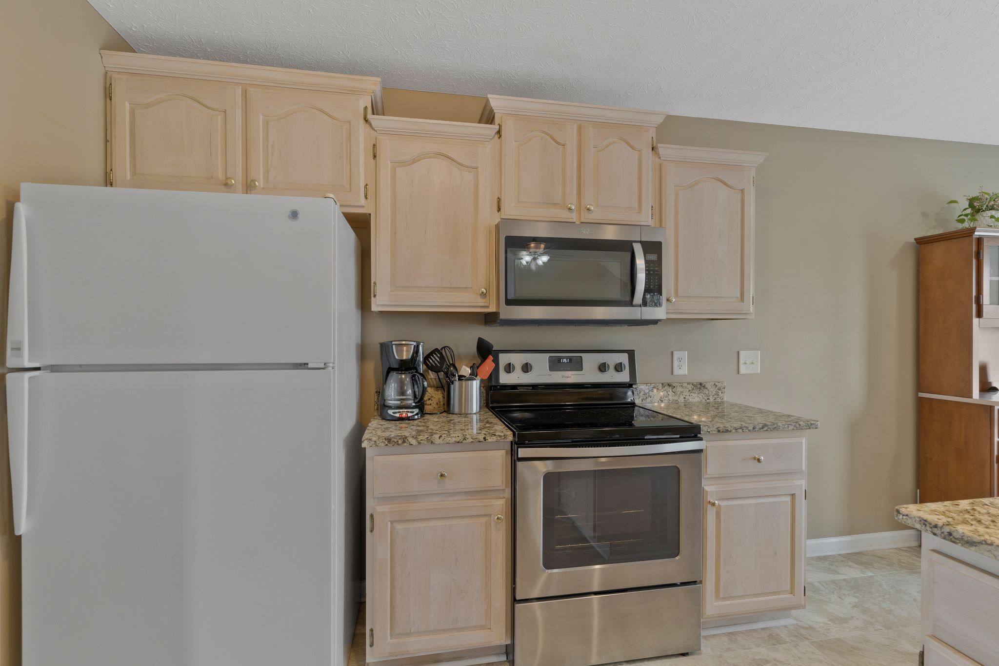 153 Cornerstone Boulevard Portland, TN 37148 - Photo 12 of 30 a kitchen with refrigerator a stove a microwave and cabinets