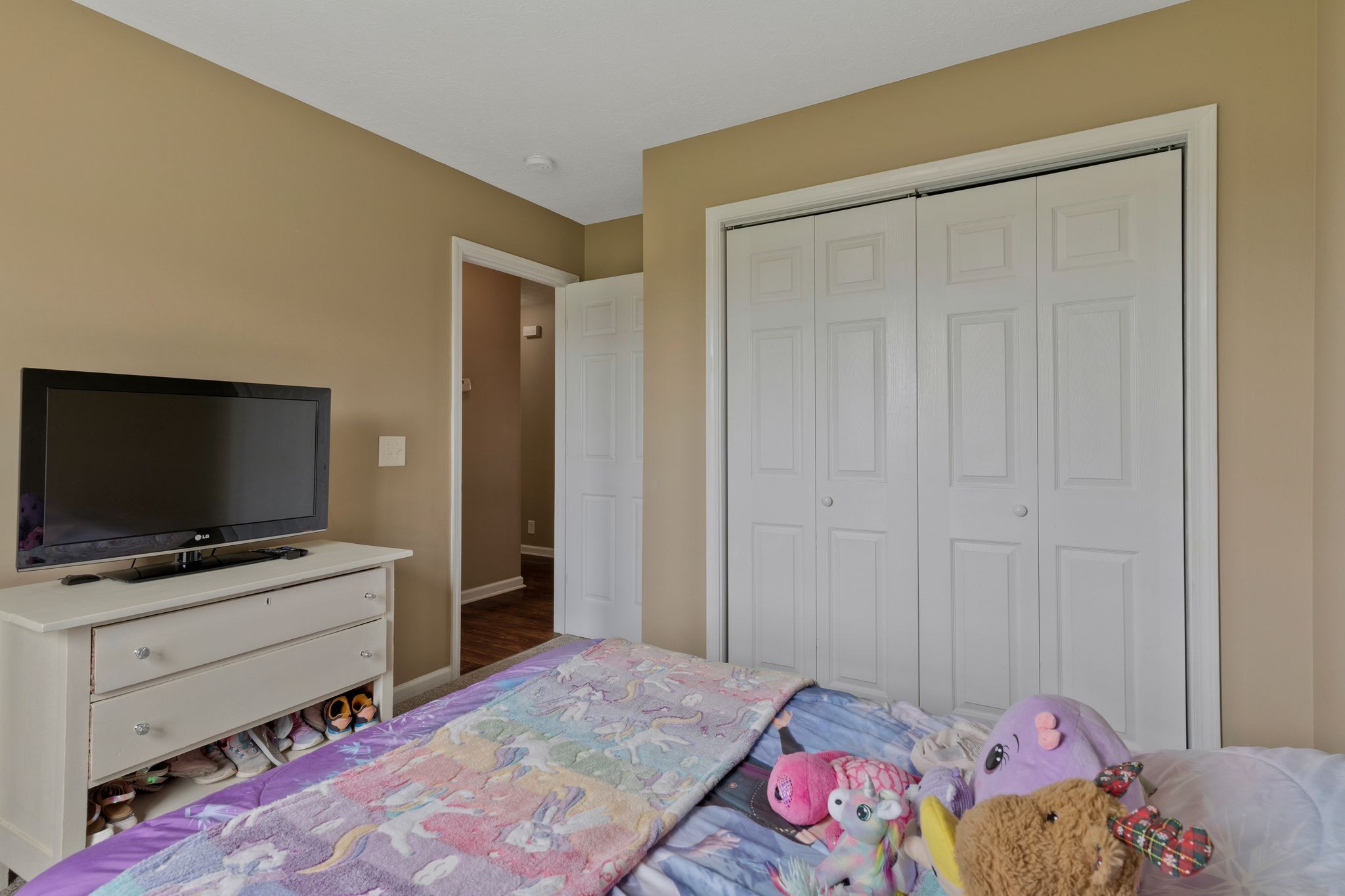 153 Cornerstone Boulevard Portland, TN 37148 - Photo 24 of 30 a bedroom with a bed and flat screen tv