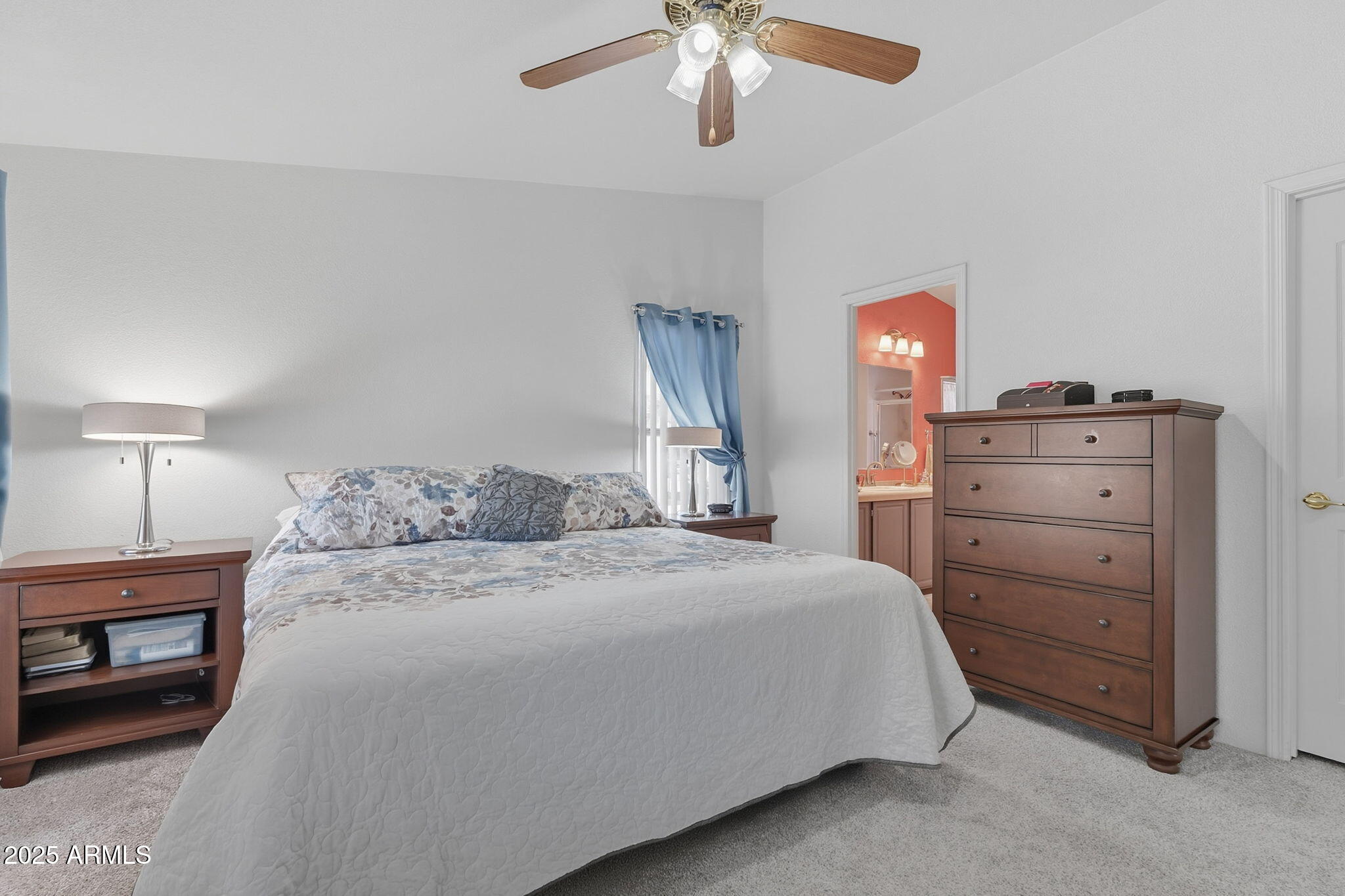 3700 South Tomahawk Road, Unit 39 Apache Junction, AZ 85119 - Photo 27 of 53 a bedroom with a bed a chandelier and a dresser