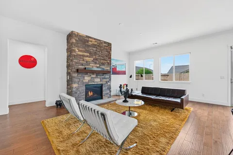 a living room with furniture rug and wooden floor