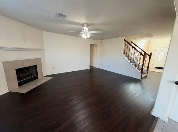 wooden floor in an empty room with a fireplace