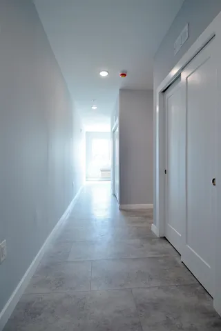 a view of hallway with a ceiling fan