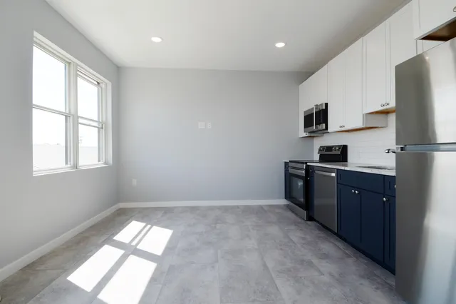 a kitchen with stainless steel appliances a refrigerator sink and cabinets