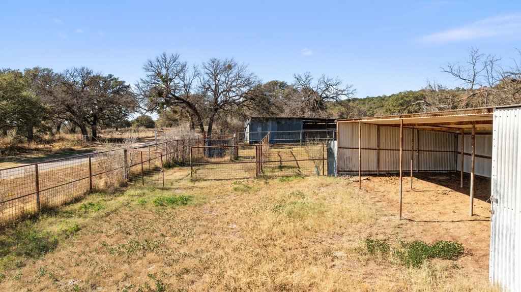 1101 Crider Road Marble Falls, TX 78654 - Photo 13 of 34 View of yard featuring an outbuilding, an exterior structure, and a carport