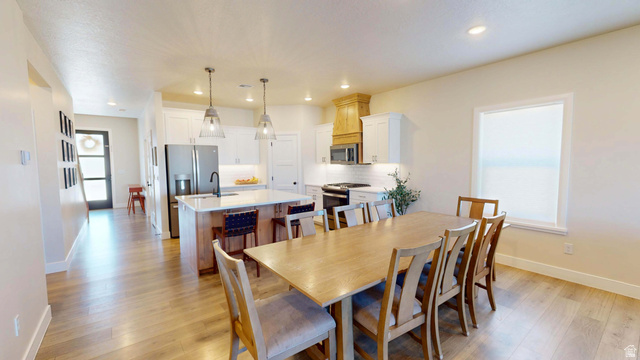 1127 4240 North Enoch, UT 84721 - Photo 13 of 56 Dining area featuring light wood finished floors, recessed lighting, and healthy amount of natural light