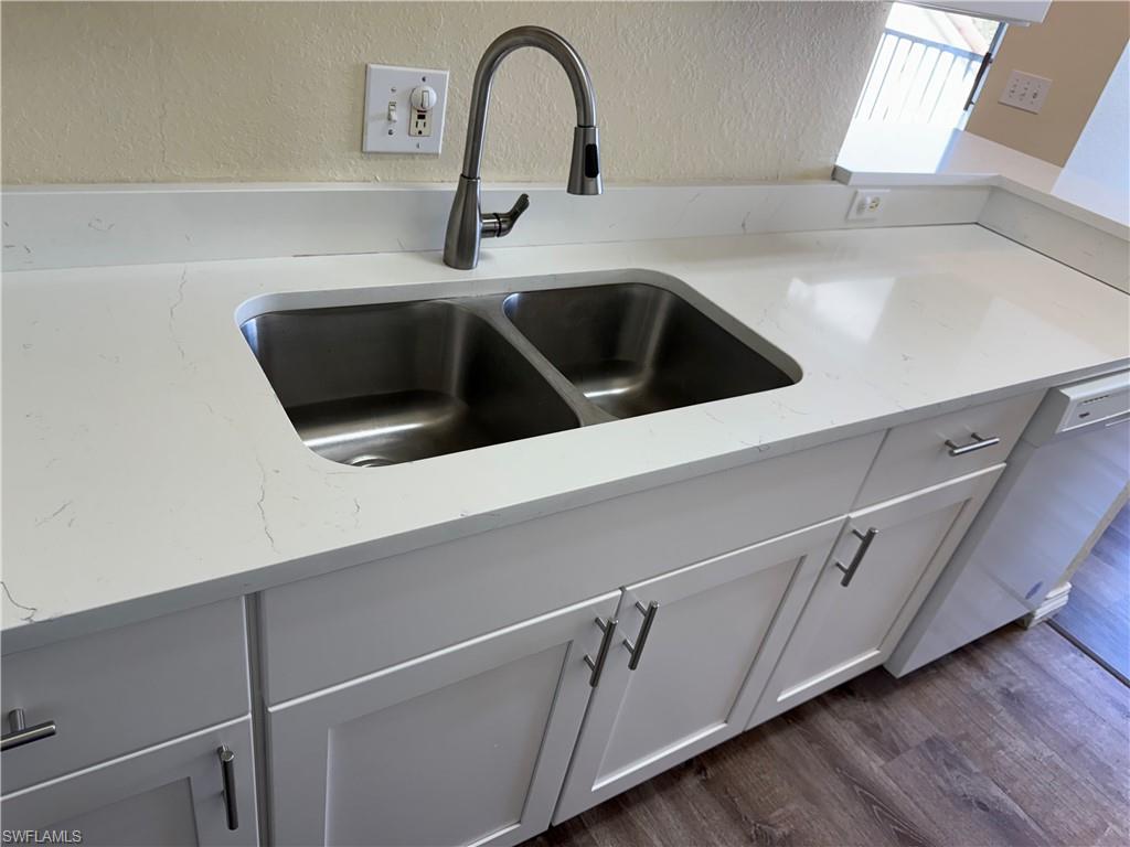 7985 Preserve Circle, Unit 1133 Naples, FL 34119 - Photo 11 of 36 a close view of a sink and a microwave in a kitchen