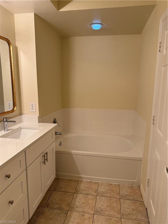 7985 Preserve Circle, Unit 1133 Naples, FL 34119 - Photo 21 of 36 a bathroom with a sink a toilet and a mirror