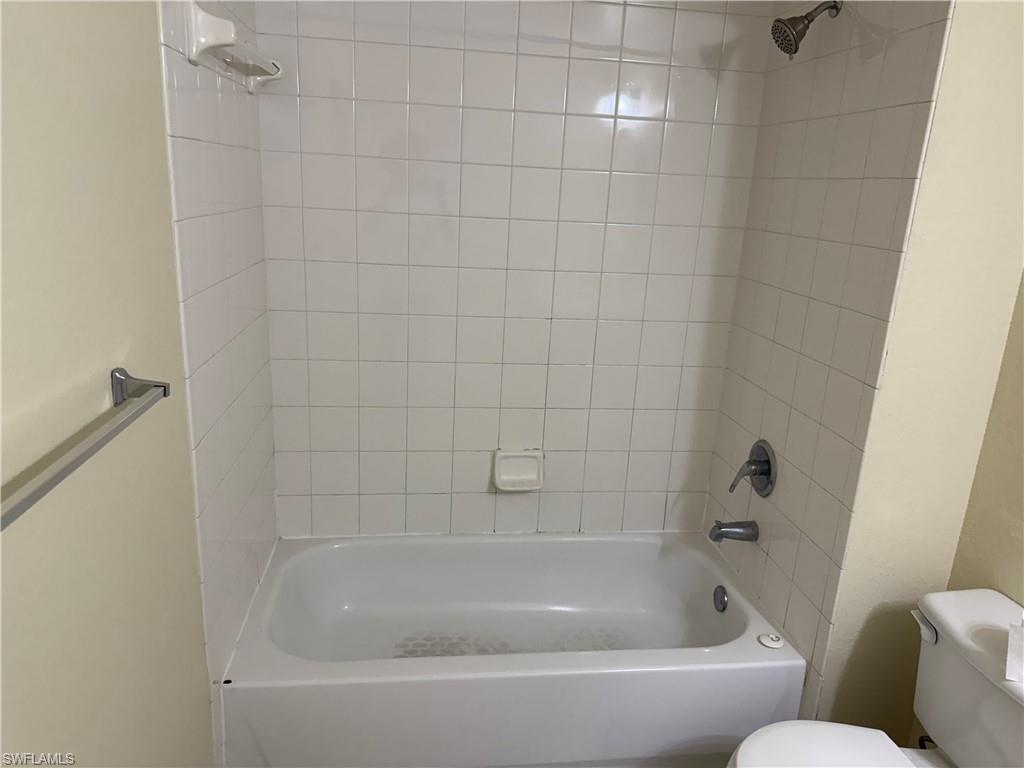 7985 Preserve Circle, Unit 1133 Naples, FL 34119 - Photo 32 of 36 Bathroom featuring shower / washtub combination and toilet