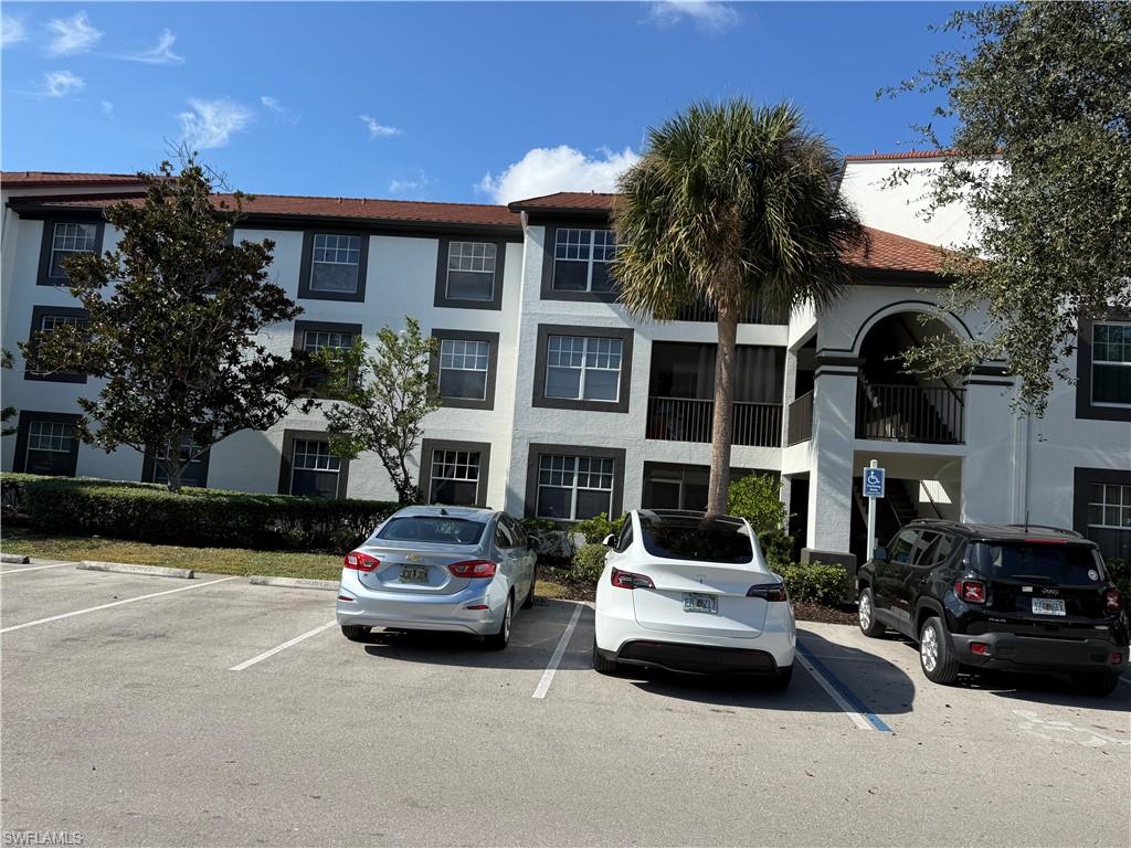 7985 Preserve Circle, Unit 1133 Naples, FL 34119 - Photo 36 of 36 View of apartment building / complex featuring uncovered parking