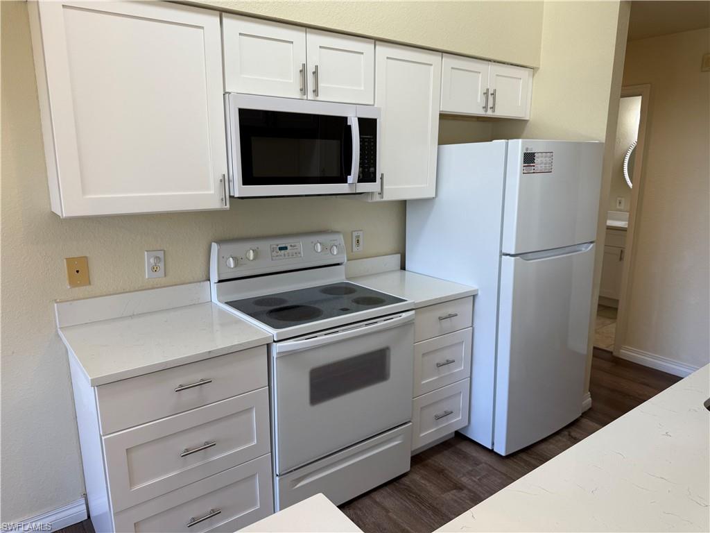 7985 Preserve Circle, Unit 1133 Naples, FL 34119 - Photo 8 of 36 a kitchen with a stove microwave and refrigerator