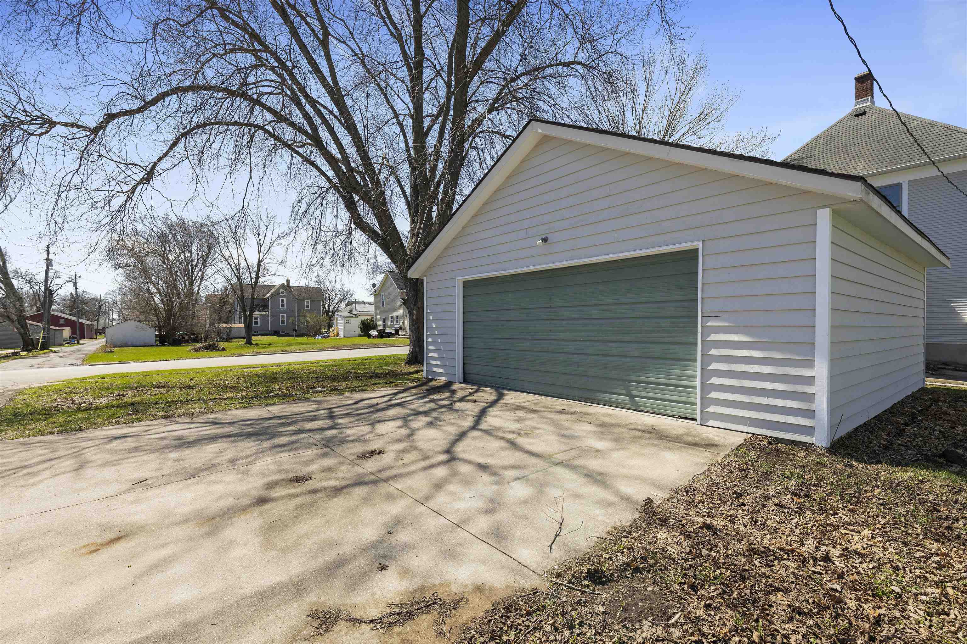 703 North Main Street Rochelle, IL 61068 - Photo 20 of 21 a view of a house with a yard and garage