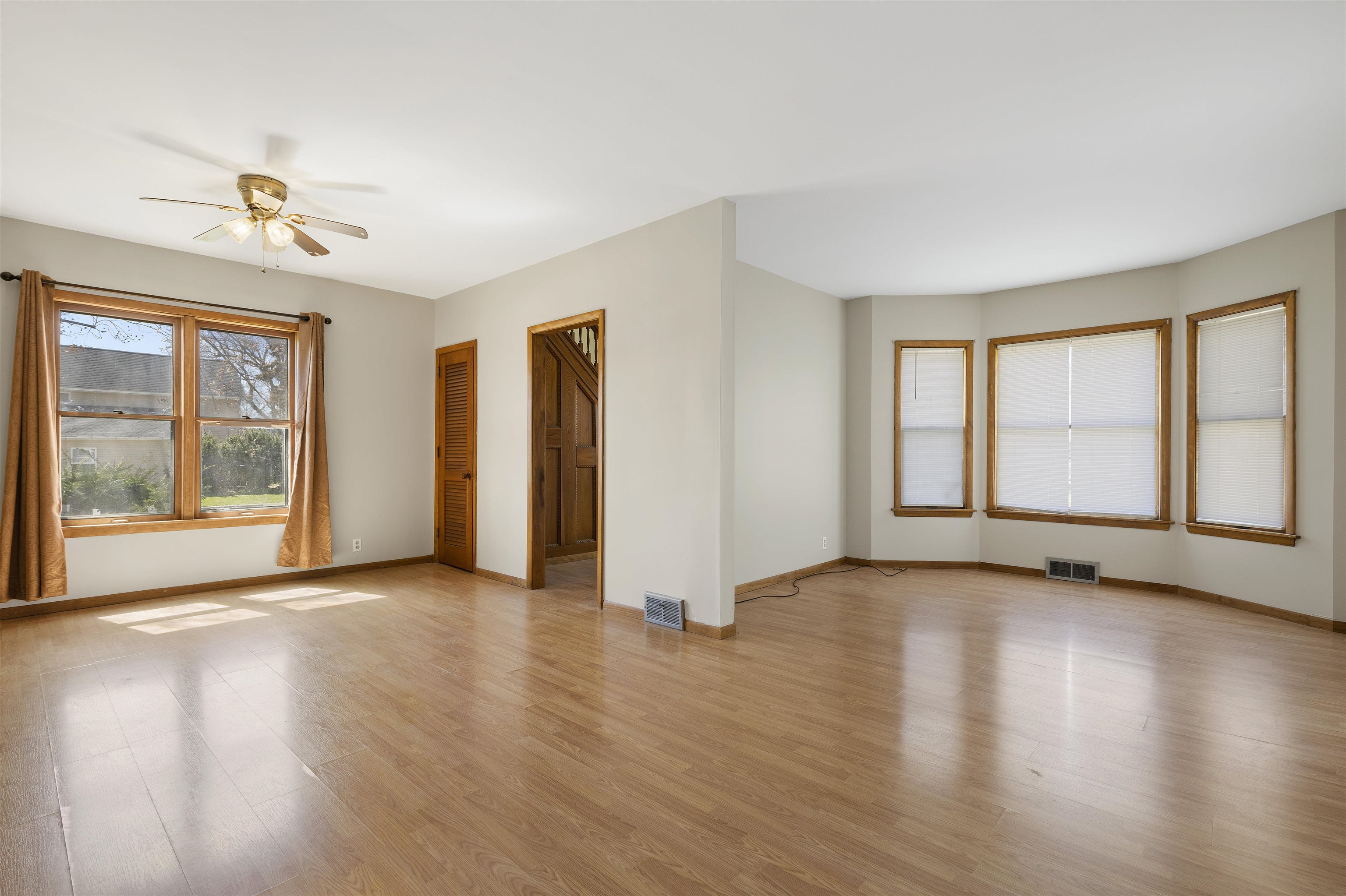 703 North Main Street Rochelle, IL 61068 - Photo 4 of 21 a view of an empty room with a window and wooden floor