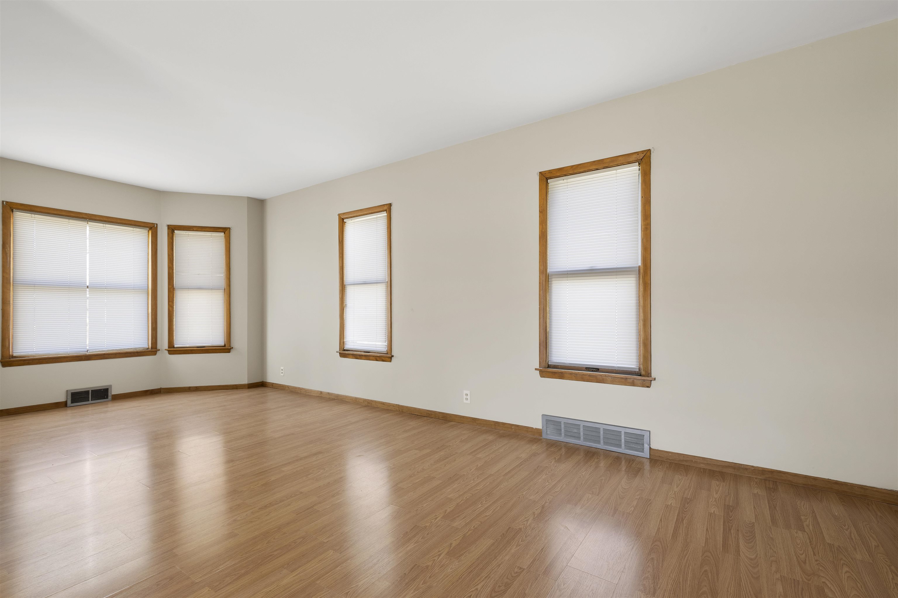 703 North Main Street Rochelle, IL 61068 - Photo 6 of 21 an empty room with wooden floor and windows