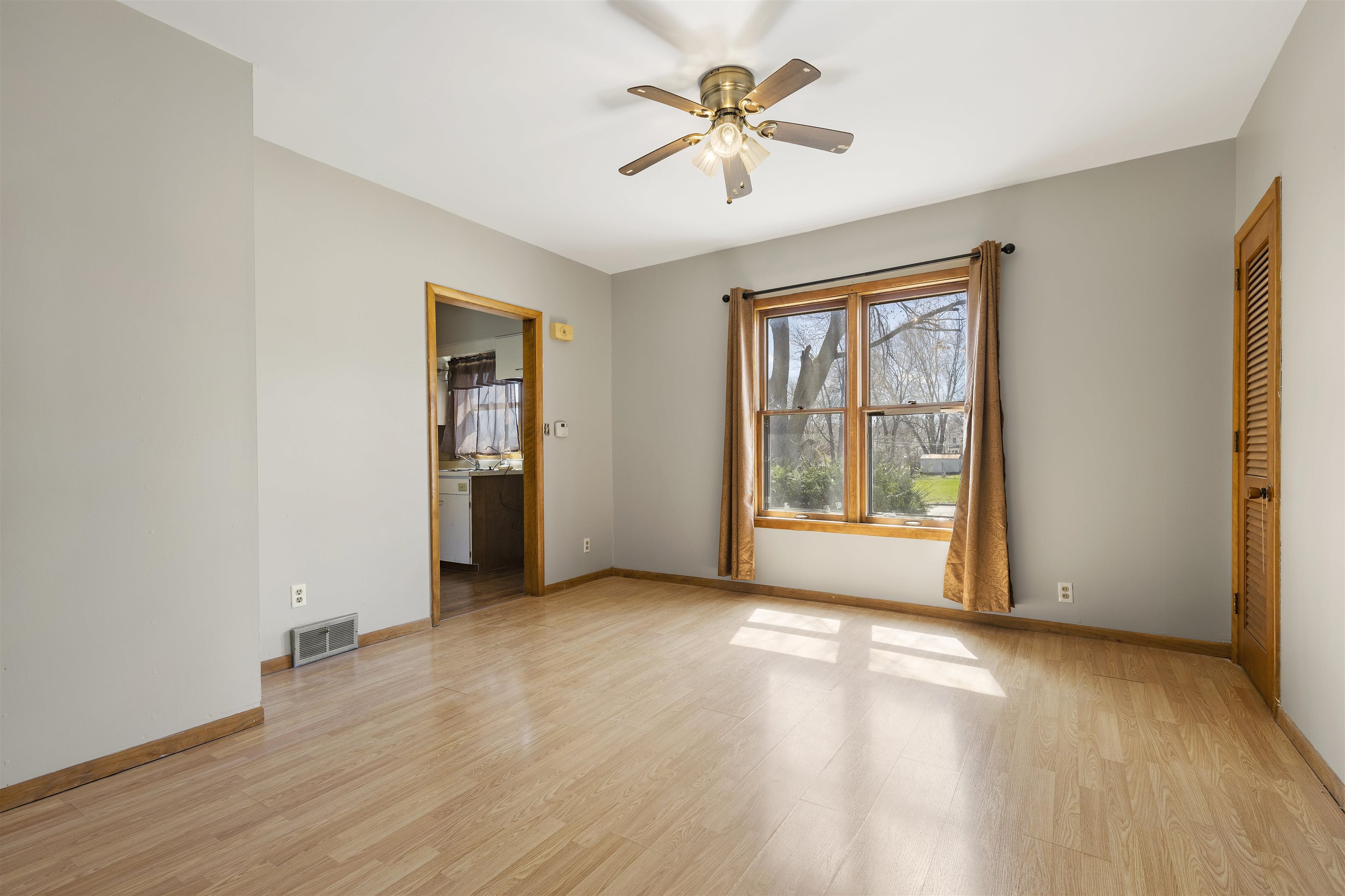 703 North Main Street Rochelle, IL 61068 - Photo 7 of 21 an empty room with wooden floor and windows