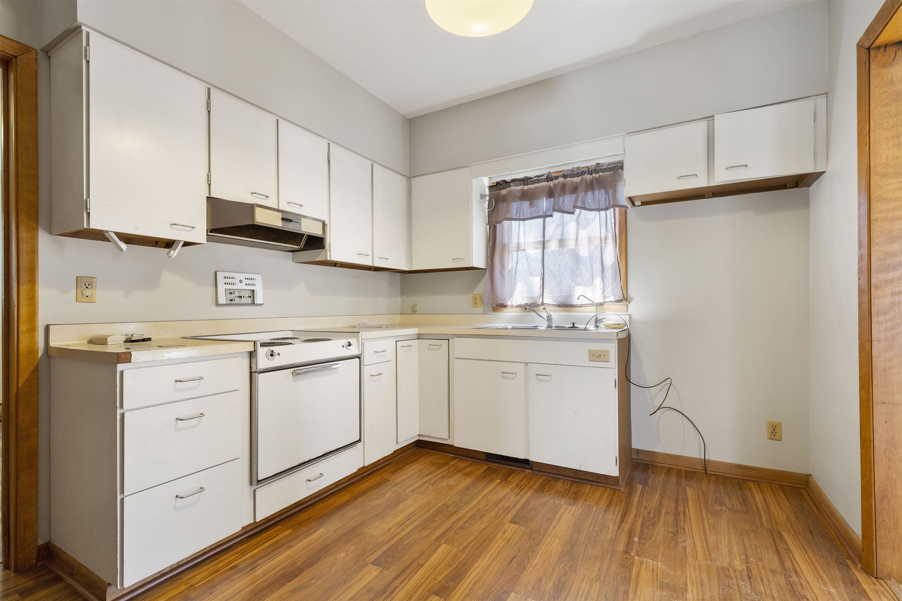 703 North Main Street Rochelle, IL 61068 - Photo 8 of 21 a kitchen with granite countertop white cabinets and white appliances