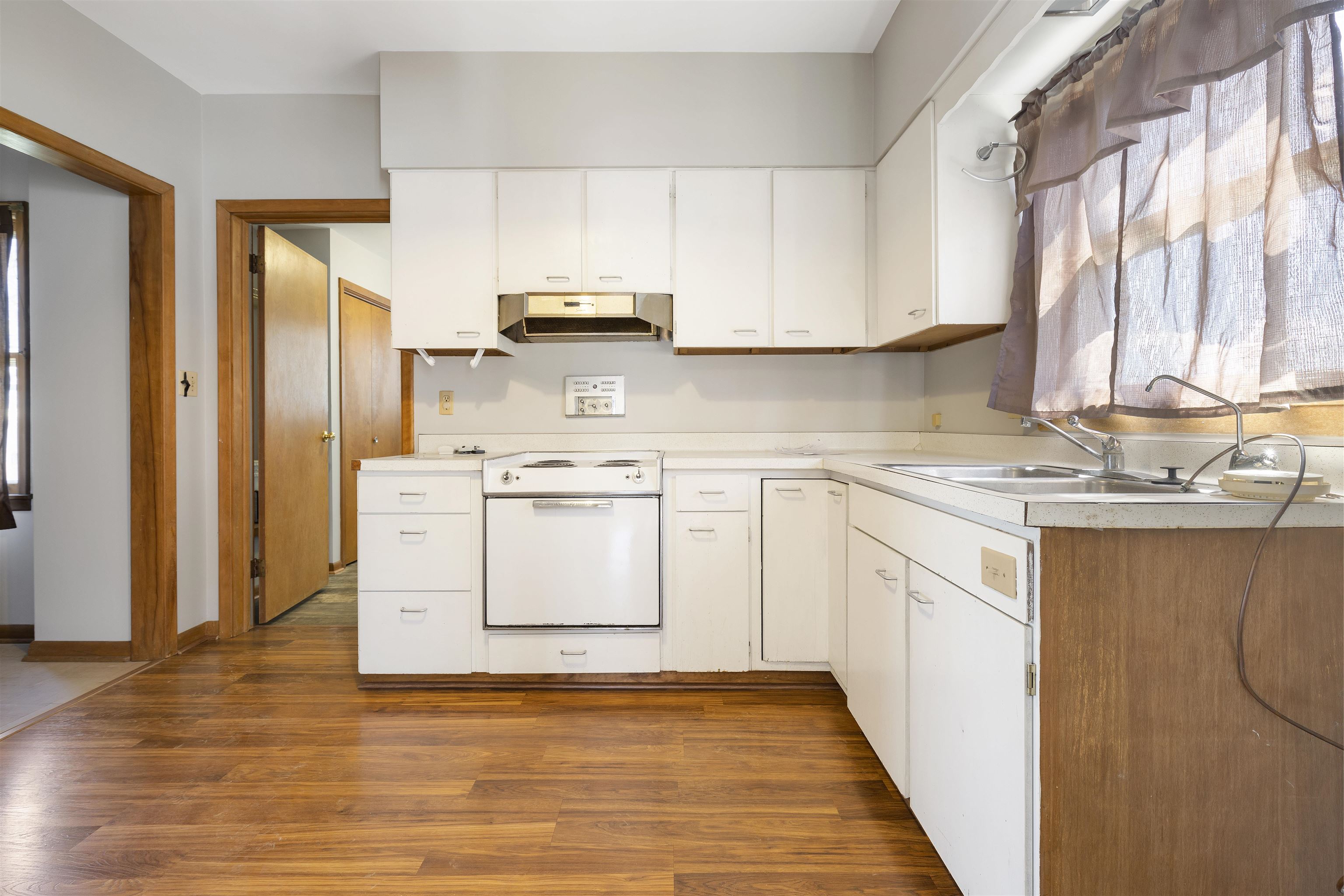 703 North Main Street Rochelle, IL 61068 - Photo 9 of 21 a kitchen with a sink a window and stainless steel appliances