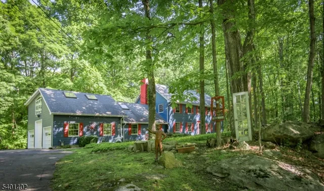 a view of an chairs and table in front of house