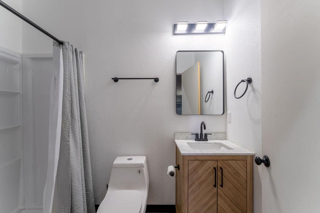 15193 Robin Road Haslet, TX 76052 - Photo 10 of 14 a bathroom with a toilet sink and mirror