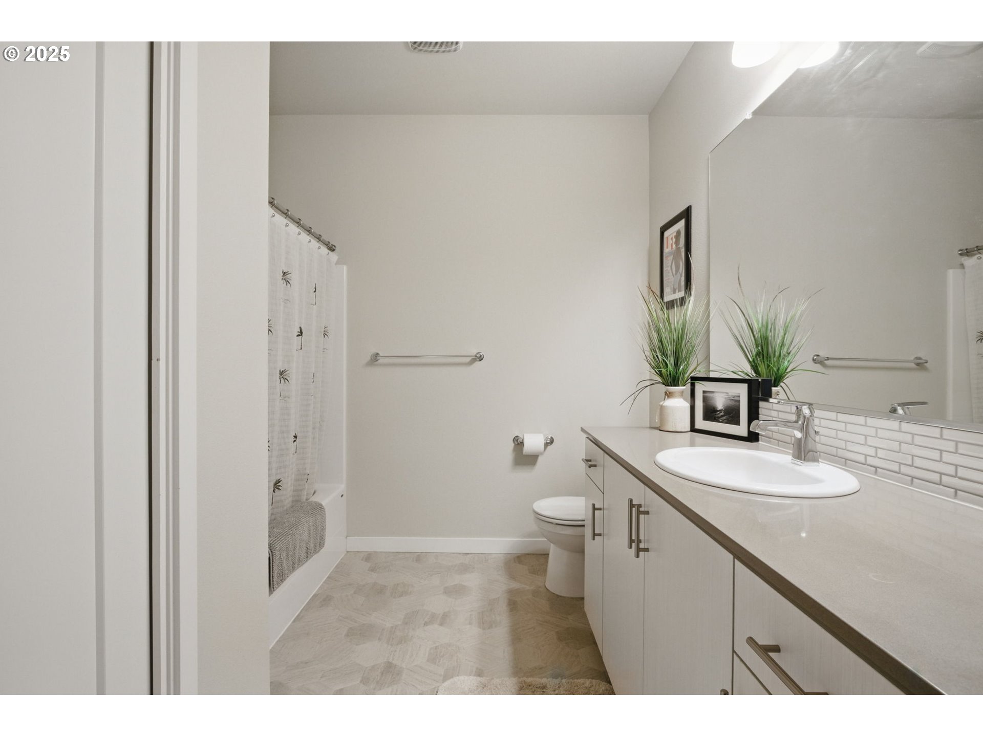 16322 Northwest Chadwick Way, Unit 303 Portland, OR 97229 - Photo 12 of 23 a bathroom with a granite countertop sink a toilet and a mirror