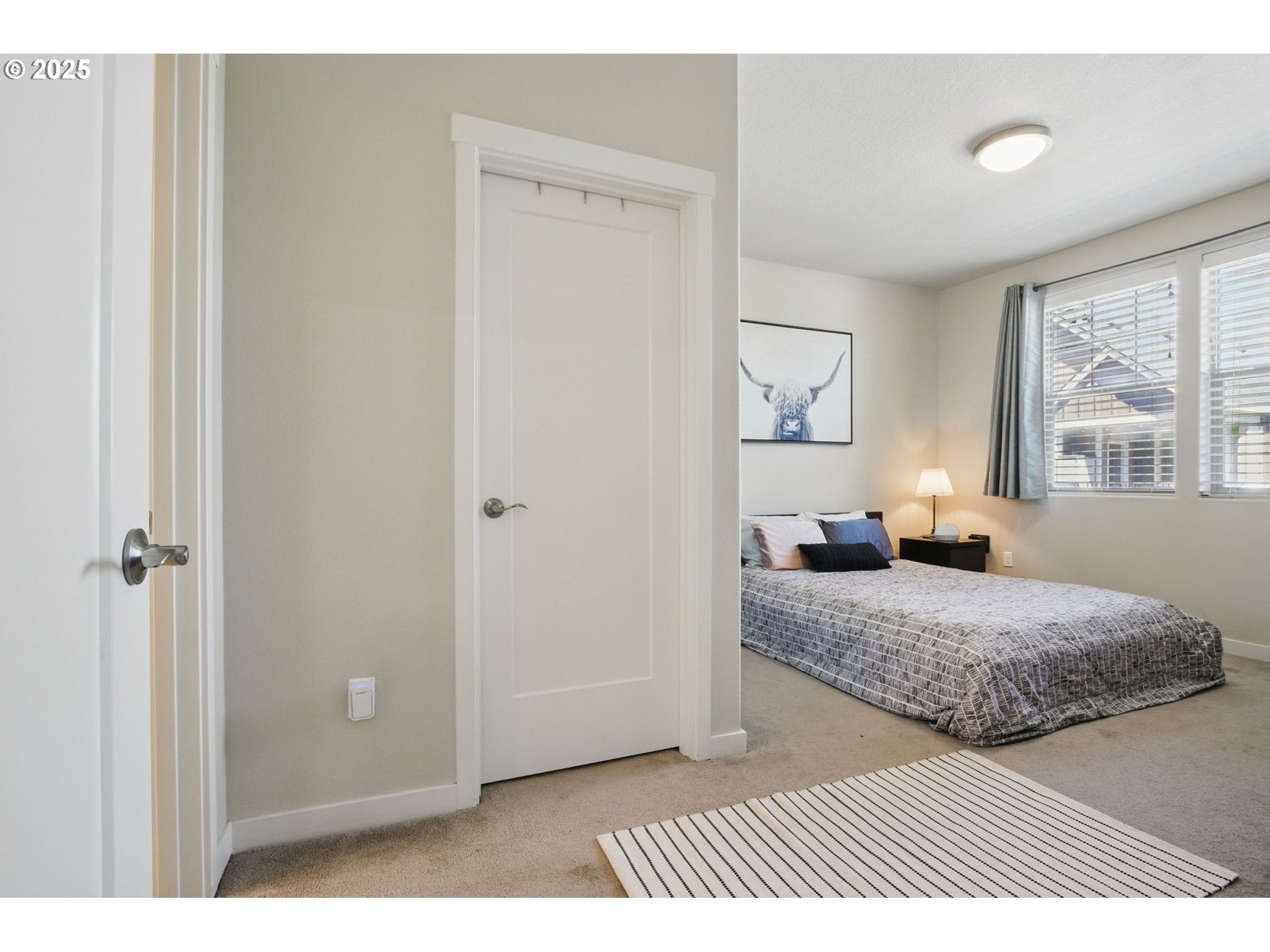 16322 Northwest Chadwick Way, Unit 303 Portland, OR 97229 - Photo 14 of 23 a bedroom with a bed and a window