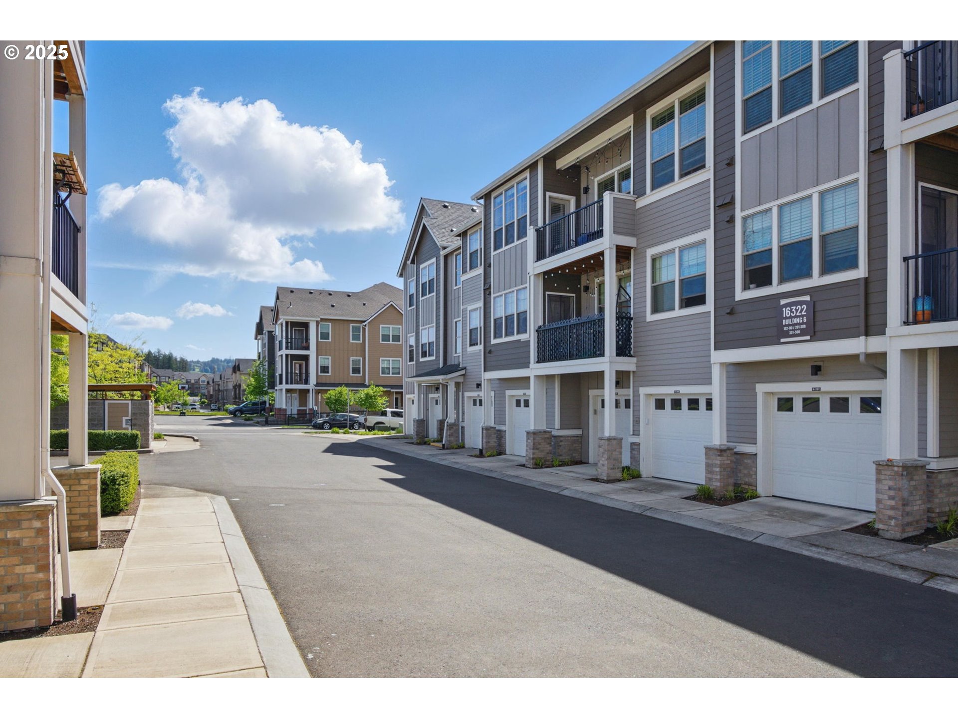 16322 Northwest Chadwick Way, Unit 303 Portland, OR 97229 - Photo 21 of 23 a city street lined with tall buildings