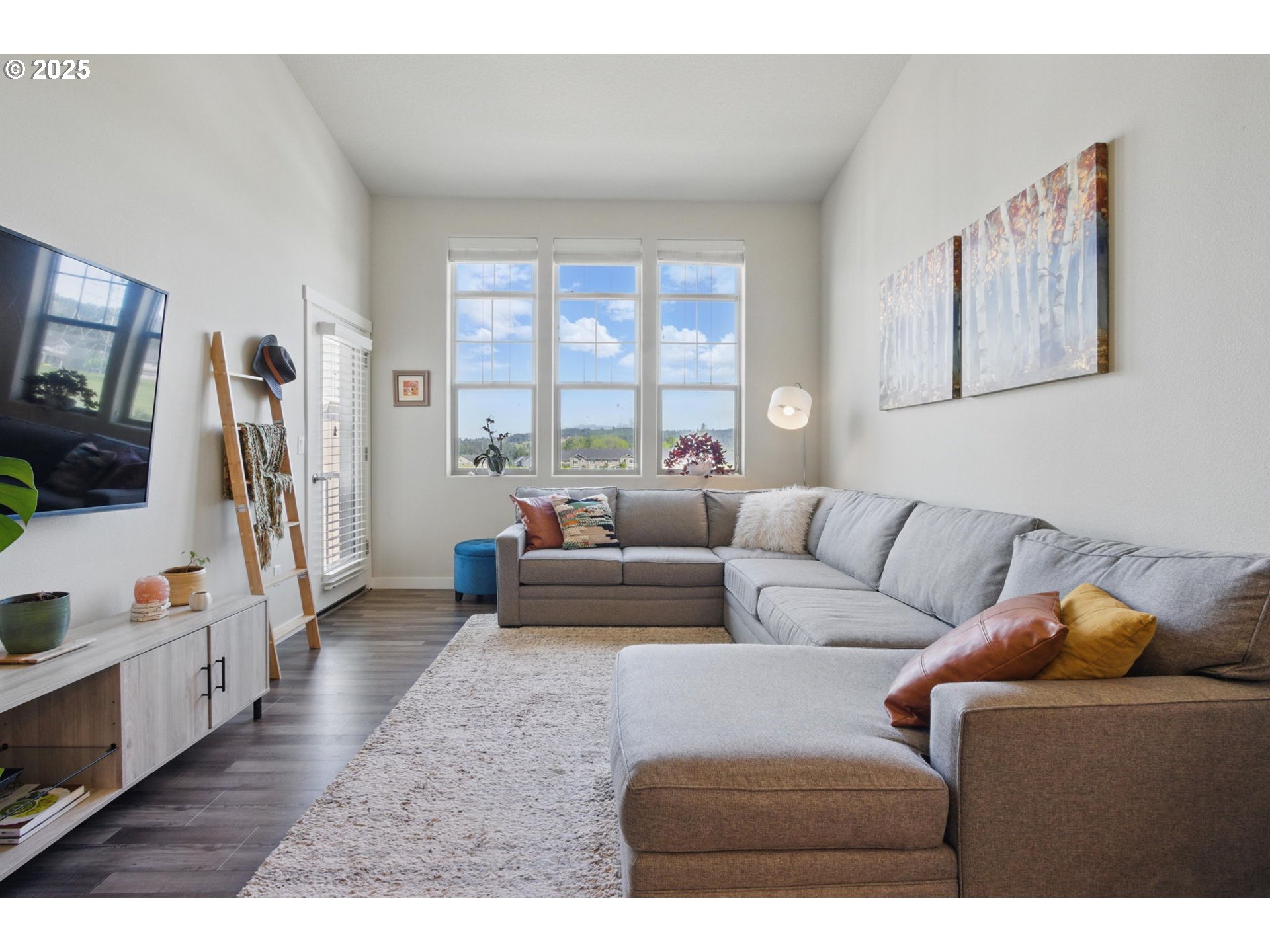 16322 Northwest Chadwick Way, Unit 303 Portland, OR 97229 - Photo 9 of 23 a living room with furniture and a flat screen tv