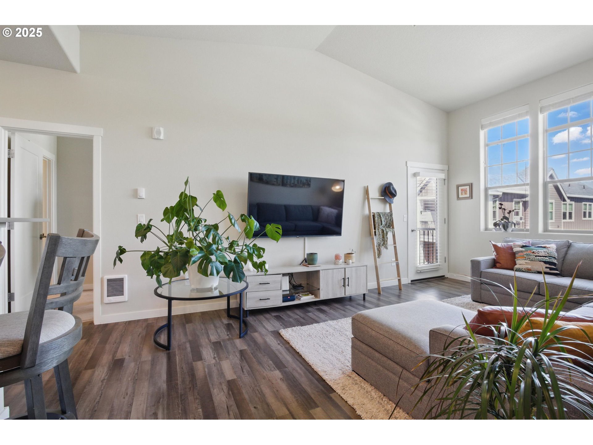 16322 Northwest Chadwick Way, Unit 303 Portland, OR 97229 - Photo 10 of 23 a living room with furniture and a flat screen tv
