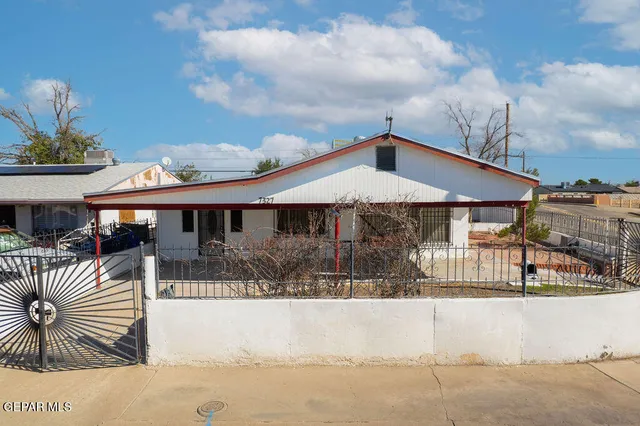 a front view of a house with a wooden fence