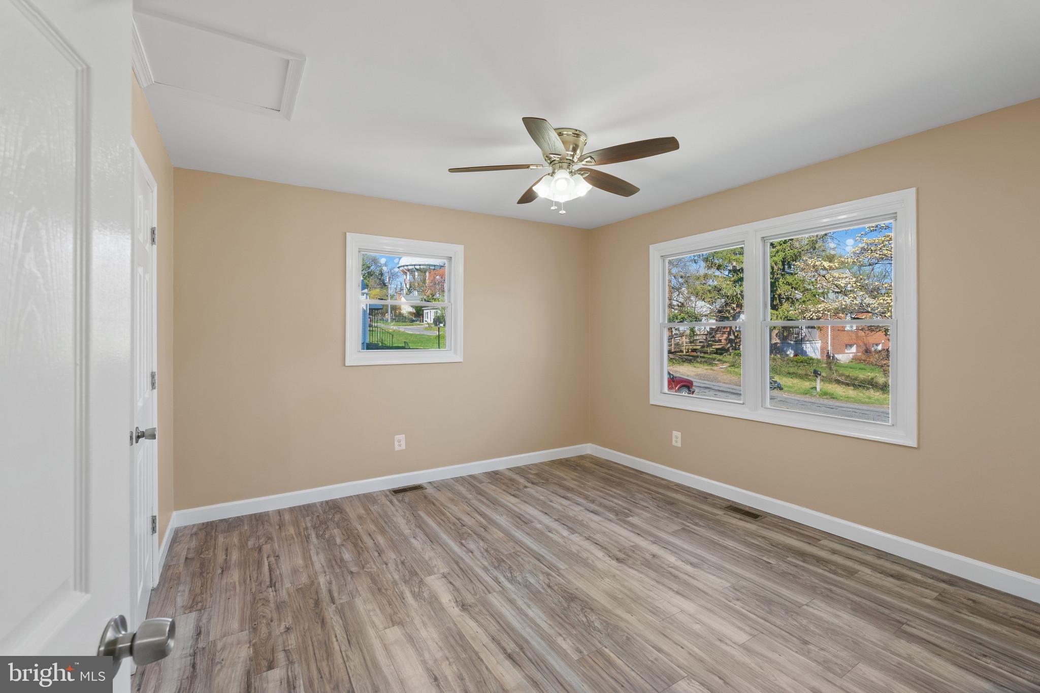 712 Kent Avenue Baltimore, MD 21228 - Photo 11 of 30 a view of room with window ceiling fan and wooden floor