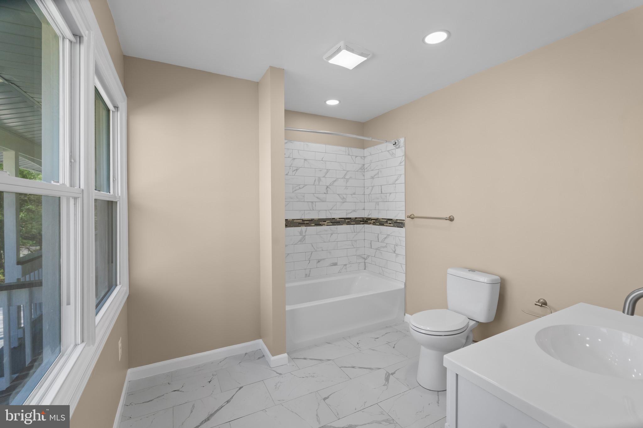 712 Kent Avenue Baltimore, MD 21228 - Photo 13 of 30 a bathroom with a toilet and a shower