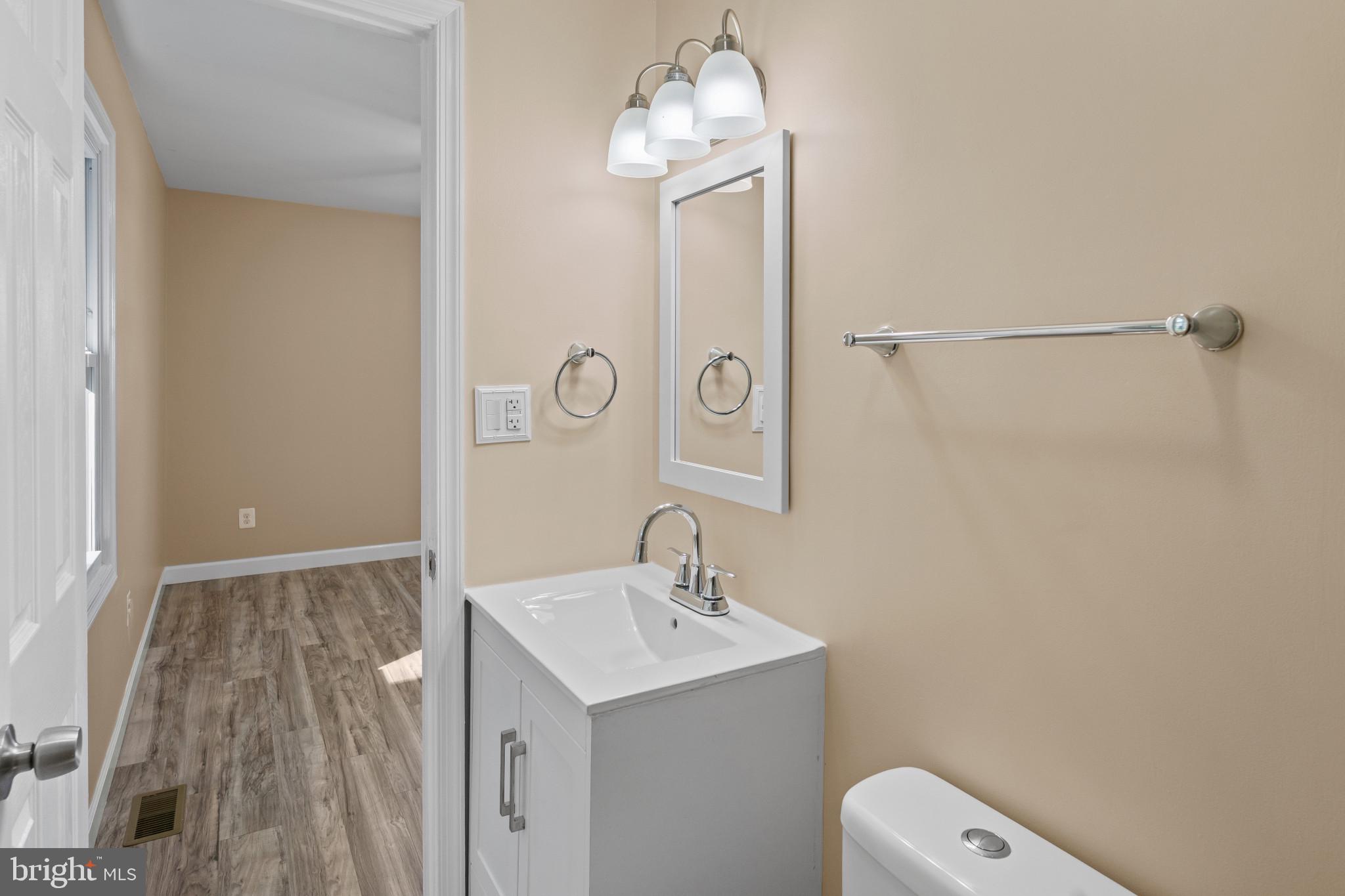 712 Kent Avenue Baltimore, MD 21228 - Photo 17 of 30 a bathroom with a sink a toilet and shower