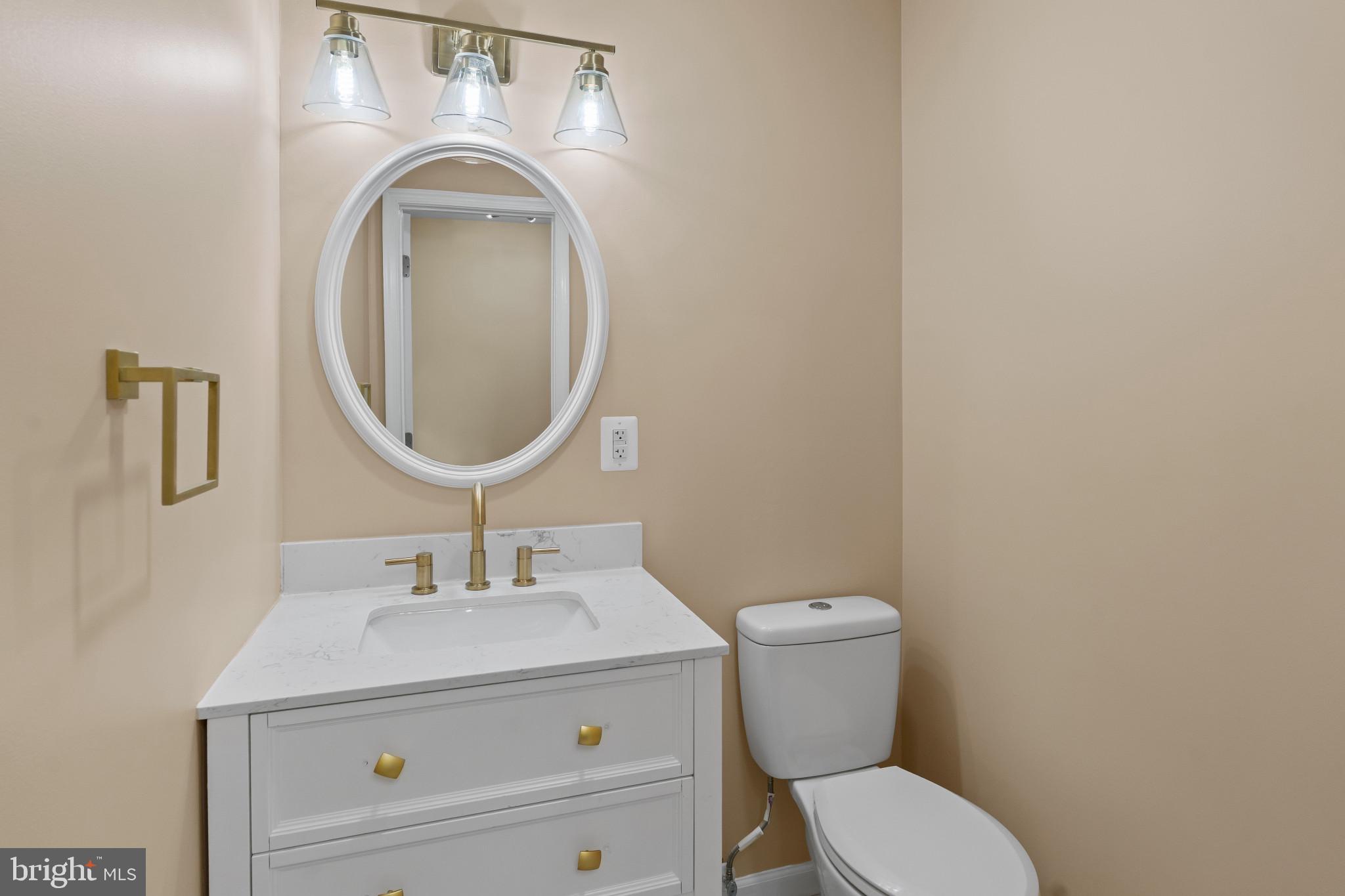 712 Kent Avenue Baltimore, MD 21228 - Photo 18 of 30 a bathroom with a toilet sink and mirror