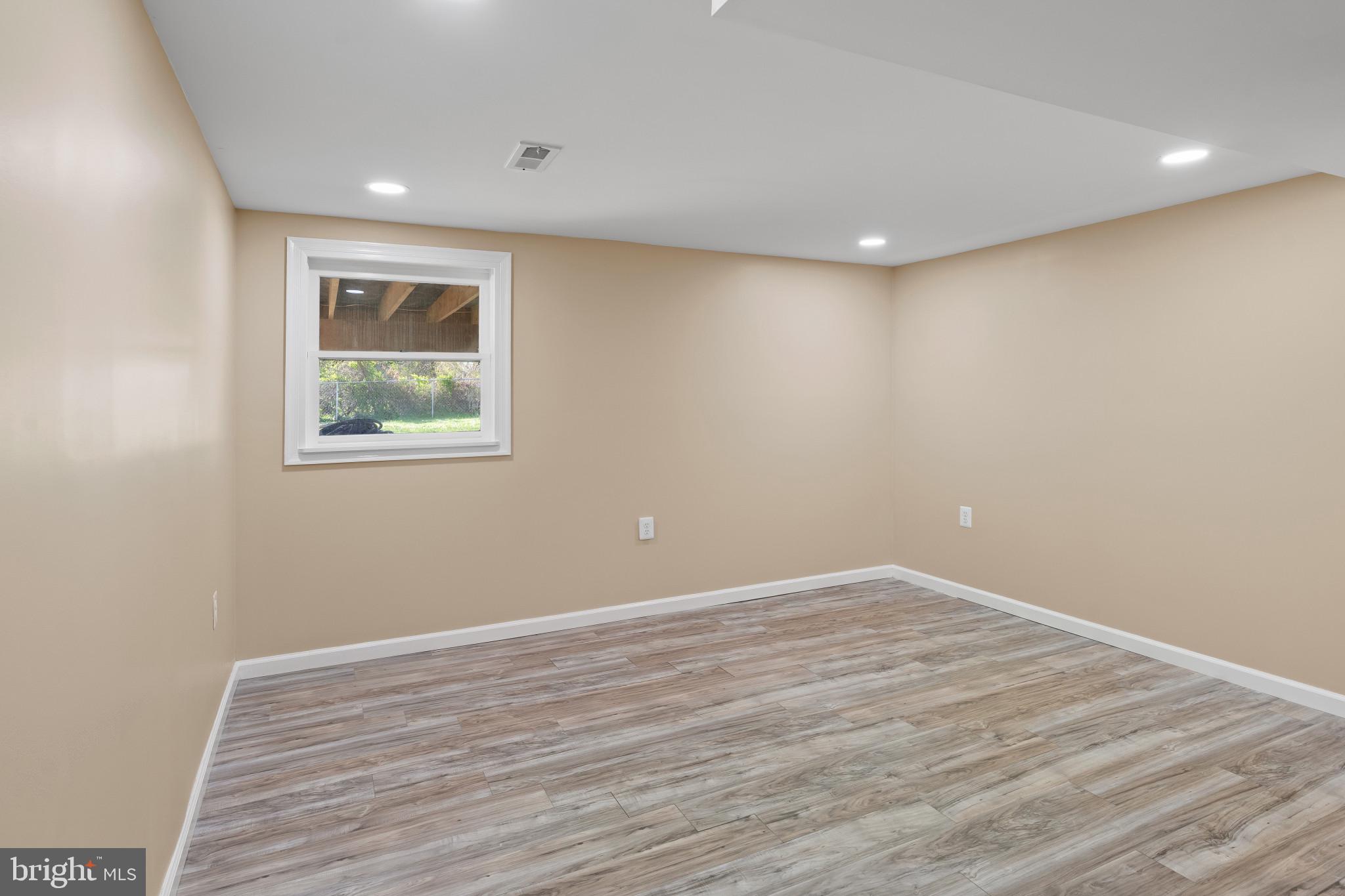 712 Kent Avenue Baltimore, MD 21228 - Photo 20 of 30 a view of room with window and wooden floor