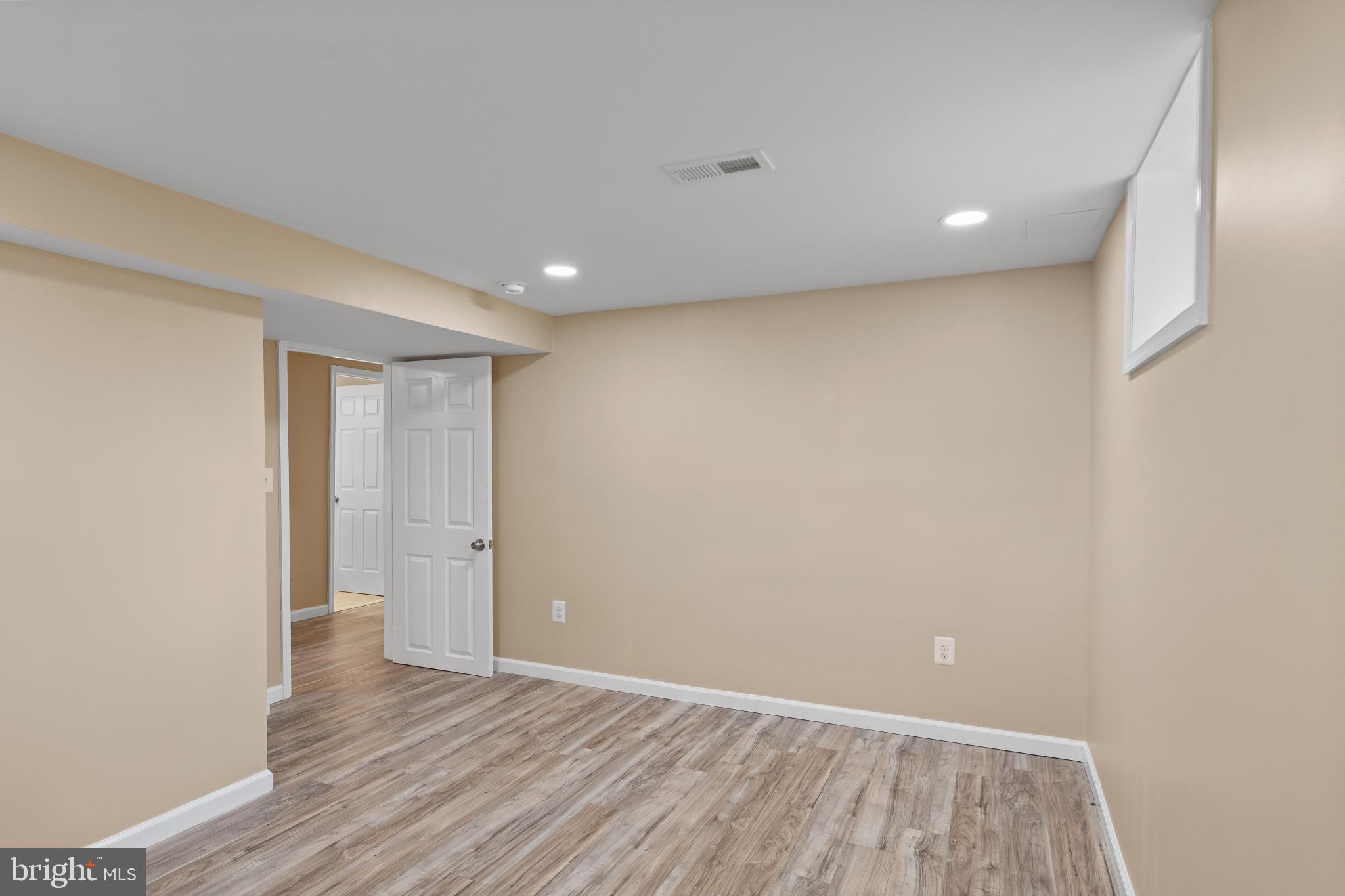 712 Kent Avenue Baltimore, MD 21228 - Photo 25 of 30 a view of an empty room with wooden floor