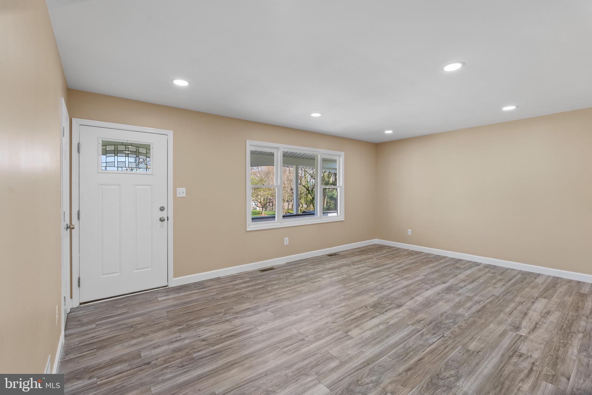 712 Kent Avenue Baltimore, MD 21228 - Photo 6 of 30 a view of an empty room with wooden floor and window