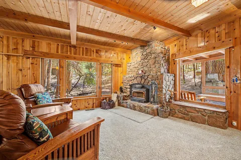 a living room with furniture and large windows