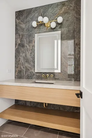 a view of kitchen with stainless steel appliances kitchen island wooden cabinets and entryway