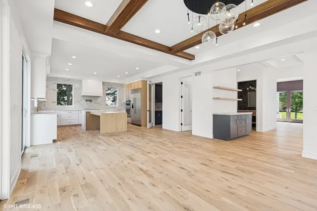 a view of a big room with wooden floor and a bathroom