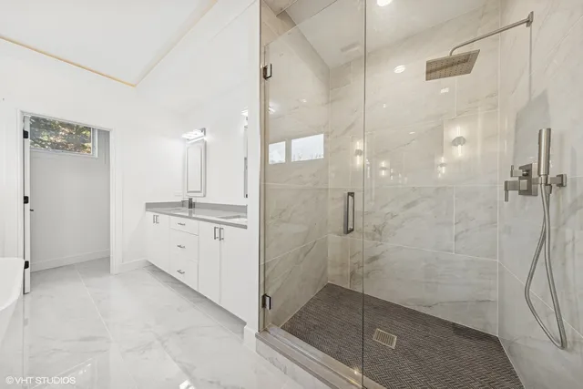 a bathroom with a granite countertop sink toilet and bathtub